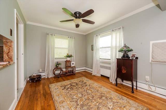 doorway to outside with wood-type flooring, a ceiling fan, crown molding, and a baseboard heating unit