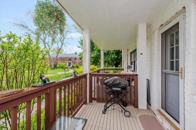 deck featuring a porch and a grill