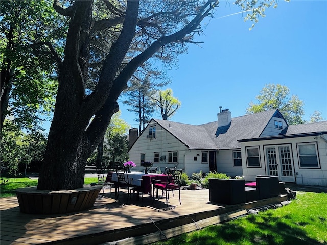 21 Rivers Dr, Great Neck, NY 11020 - rear view of house featuring a deck, roof with shingles, an outdoor living space, a chimney, and outdoor dining area
