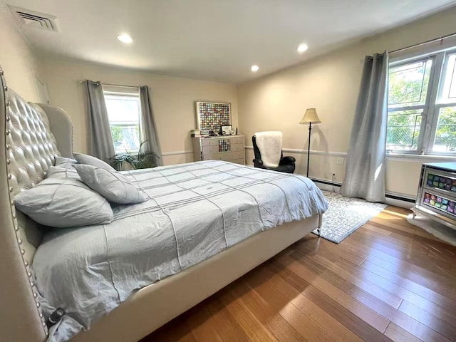 21 Rivers Dr, Great Neck, NY 11020 - bedroom featuring a baseboard radiator, wood-type flooring, recessed lighting, and a baseboard heating unit