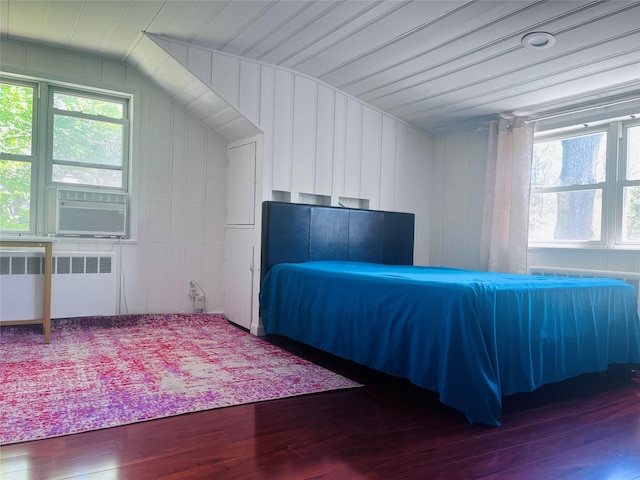 21 Rivers Dr, Great Neck, NY 11020 - bedroom with radiator heating unit, wood finished floors, multiple windows, vaulted ceiling, and cooling unit