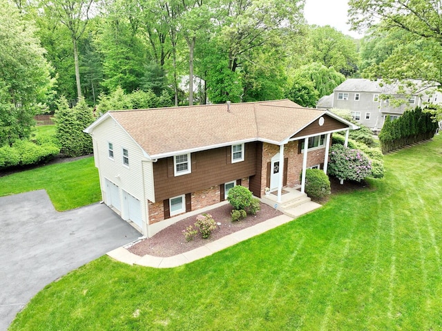 4 Stockbridge Ave, Suffern, NY 10901 - raised ranch with driveway, a front yard, a garage, and a shingled roof