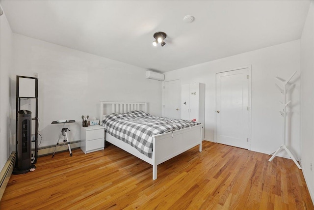 109 Wilton St, New Hyde Park, NY 11040 - bedroom with a baseboard radiator, a wall unit AC, and light wood-type flooring