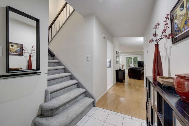 141 Southgate Dr, Massapequa Park, NY 11762 - entryway with stairway and light tile patterned floors