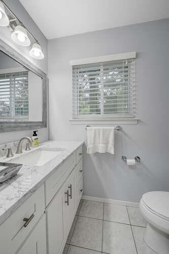 141 Southgate Dr, Massapequa Park, NY 11762 - bathroom with healthy amount of natural light, baseboards, toilet, and vanity