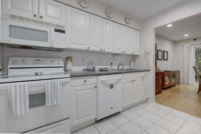 141 Southgate Dr, Massapequa Park, NY 11762 - kitchen with white appliances, white cabinets, a sink, recessed lighting, and light tile patterned floors