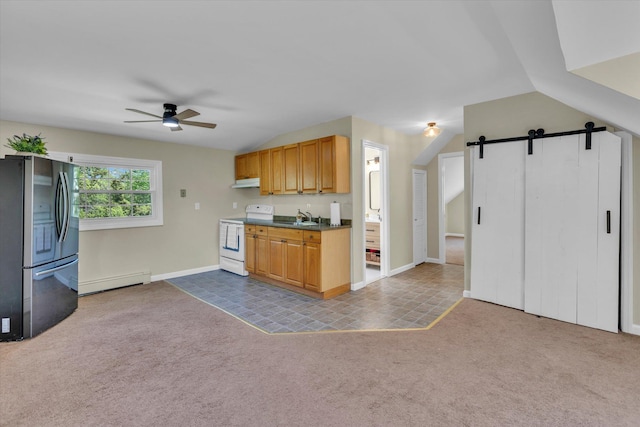 kitchen with white range with electric cooktop, freestanding refrigerator, a barn door, a ceiling fan, and a sink
