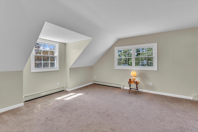 additional living space featuring baseboard heating, lofted ceiling, carpet, and plenty of natural light