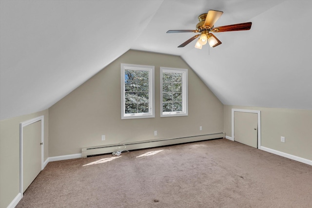 additional living space with a baseboard radiator, carpet, baseboards, lofted ceiling, and ceiling fan