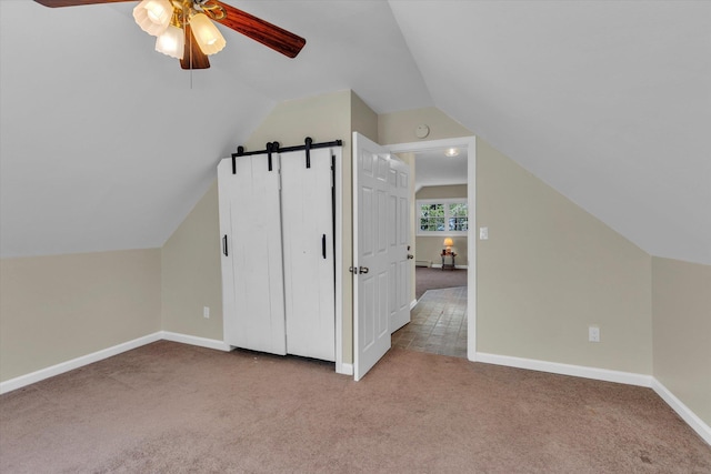 additional living space with ceiling fan, carpet, lofted ceiling, and baseboards