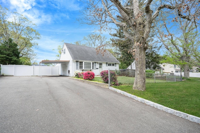 187 Mark Tree Rd, Centereach, NY 11720 - cape cod house featuring driveway, a carport, roof with shingles, and a gate