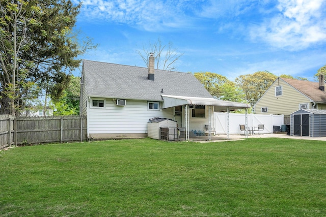 187 Mark Tree Rd, Centereach, NY 11720 - rear view of house with a shed, a patio area, a chimney, roof with shingles, and an outdoor structure
