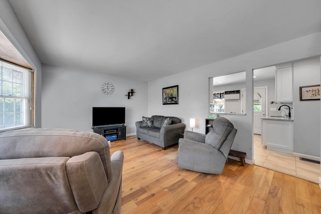 187 Mark Tree Rd, Centereach, NY 11720 - living room featuring light wood-style floors, healthy amount of natural light, and baseboards