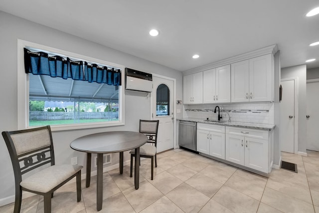 187 Mark Tree Rd, Centereach, NY 11720 - kitchen with dishwasher, a sink, white cabinets, backsplash, and light tile patterned flooring