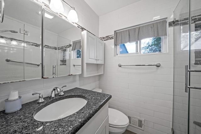 187 Mark Tree Rd, Centereach, NY 11720 - full bathroom featuring tile walls, a shower stall, toilet, and vanity