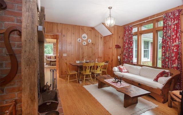 living room with wood finished floors and wood walls