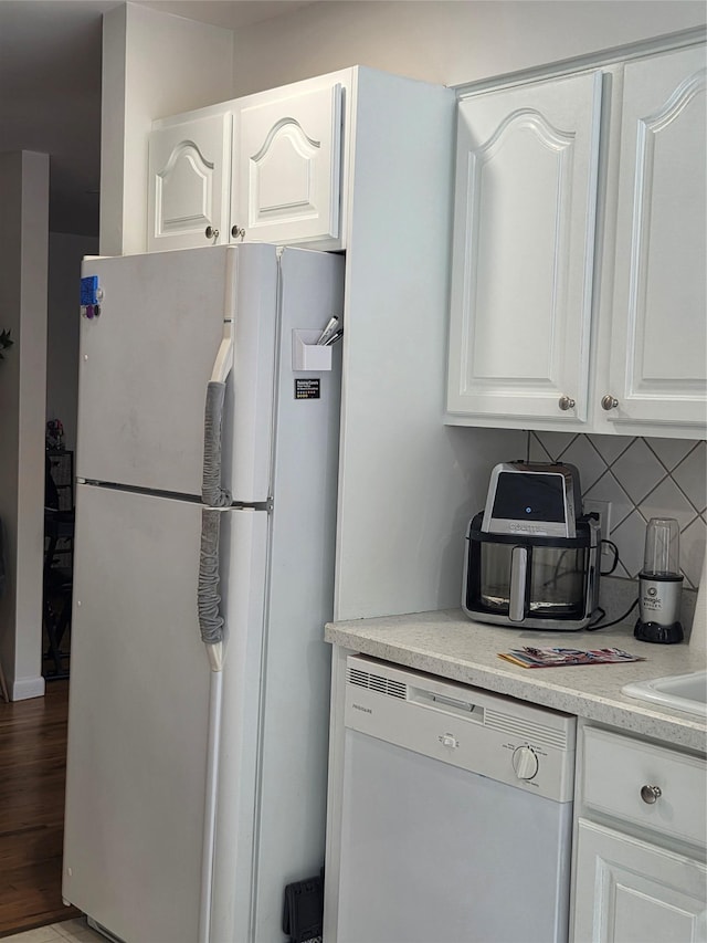 810 Blooming Grove Tpke Unit 84, New Windsor, NY 12553 - kitchen featuring white appliances, decorative backsplash, white cabinets, light countertops, and wood finished floors