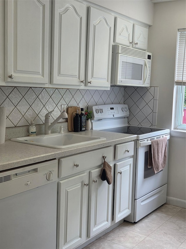 810 Blooming Grove Tpke Unit 84, New Windsor, NY 12553 - kitchen with white appliances, a sink, white cabinets, tasteful backsplash, and baseboards
