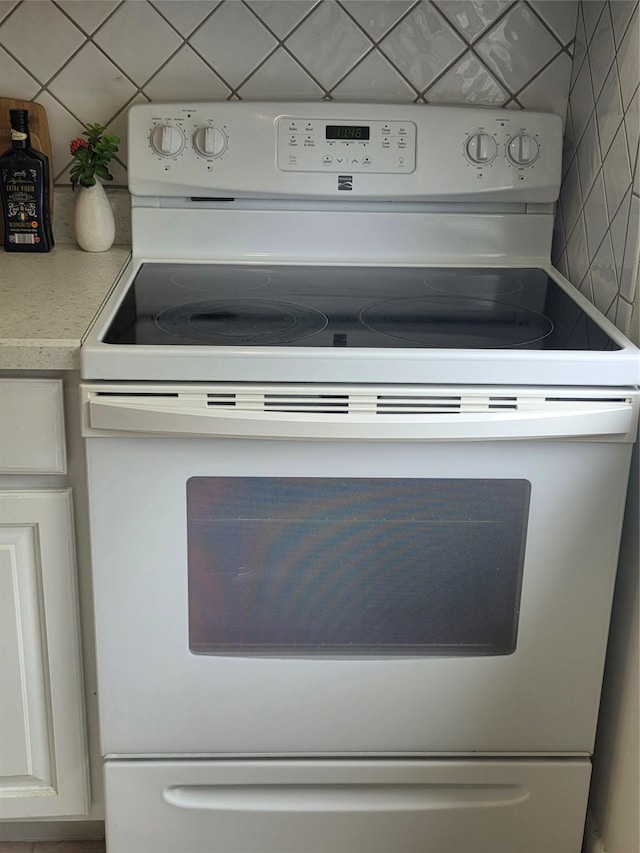 810 Blooming Grove Tpke Unit 84, New Windsor, NY 12553 - kitchen view of white range with electric cooktop, tasteful backsplash, light countertops, and white cabinetry