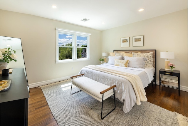 bedroom featuring baseboards, dark wood-style floors, and recessed lighting