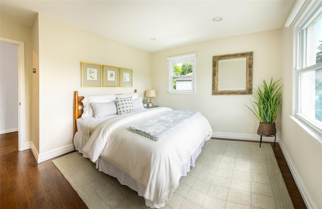bedroom featuring wood finished floors, baseboards, and recessed lighting