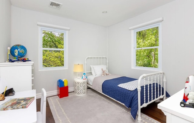 bedroom with wood finished floors and baseboards