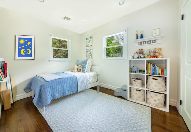 bedroom with baseboards, wood finished floors, and recessed lighting
