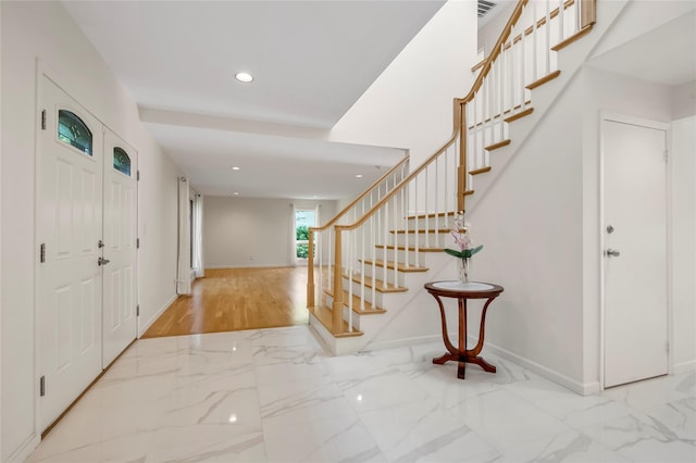 entryway with stairs, marble finish floors, recessed lighting, and baseboards