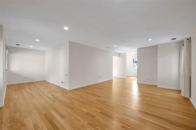 basement featuring light wood finished floors, baseboards, and recessed lighting