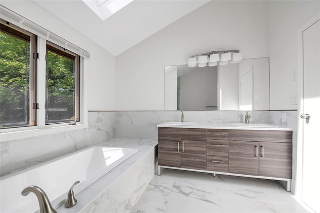 full bath with vaulted ceiling, double vanity, marble look tiles, a skylight, and a garden tub