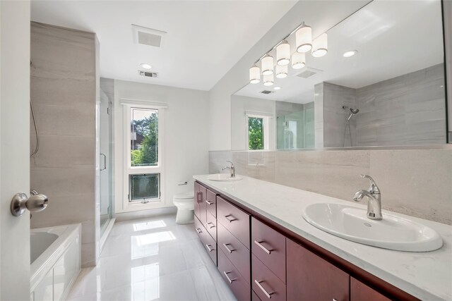full bathroom with a shower with door, toilet, double vanity, and tile patterned flooring