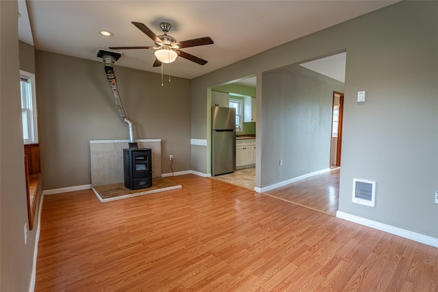 231 Stone Bridge Road Ext, Durham, NY 12423 - unfurnished living room featuring a wood stove, ceiling fan, light wood-type flooring, baseboards, and recessed lighting