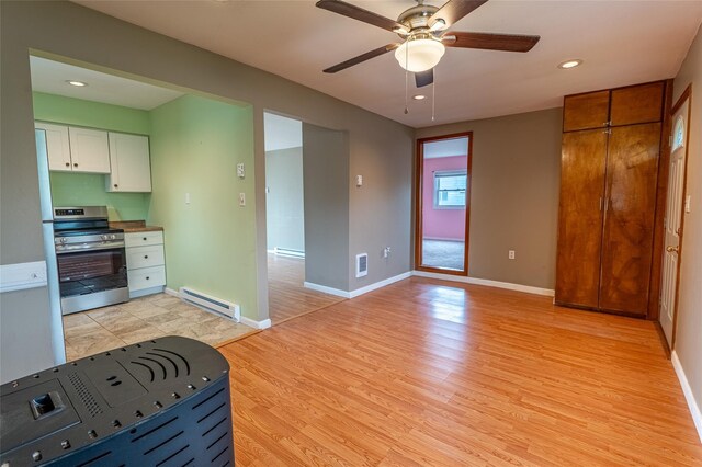 231 Stone Bridge Road Ext, Durham, NY 12423 - kitchen featuring stainless steel range with electric cooktop, baseboard heating, light wood-style floors, white cabinets, and ceiling fan