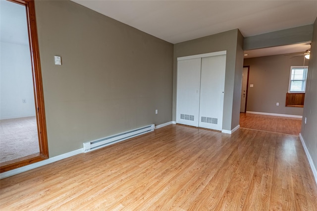 231 Stone Bridge Road Ext, Durham, NY 12423 - unfurnished bedroom featuring a baseboard heating unit, wood finished floors, baseboards, and a closet