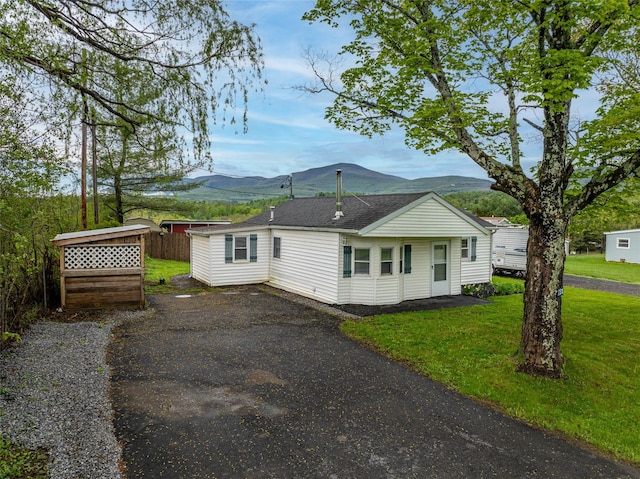 231 Stone Bridge Road Ext, Durham, NY 12423 - view of side of home featuring a mountain view, a lawn, and a shingled roof