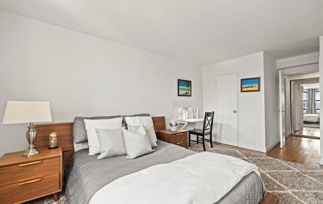 bedroom with wood finished floors and baseboards