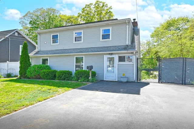63 William St, Copiague, NY 11726 - view of front of property with a gate, a chimney, and roof with shingles