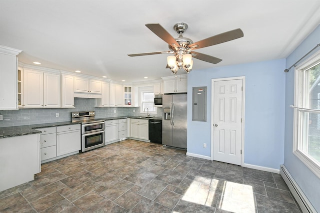 63 William St, Copiague, NY 11726 - kitchen with stainless steel appliances, baseboard heating, baseboards, a sink, and backsplash