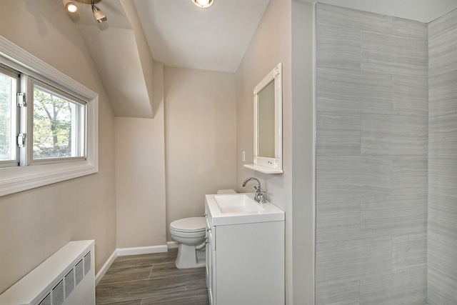 63 William St, Copiague, NY 11726 - bathroom featuring radiator heating unit, baseboards, toilet, vanity, and tiled shower