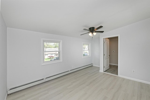 63 William St, Copiague, NY 11726 - spare room featuring a baseboard heating unit, wood finished floors, a ceiling fan, and baseboards