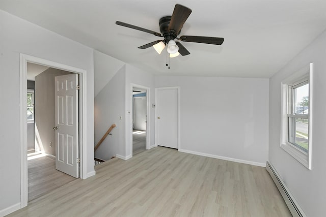 63 William St, Copiague, NY 11726 - spare room featuring baseboard heating, light wood-style floors, plenty of natural light, and baseboards
