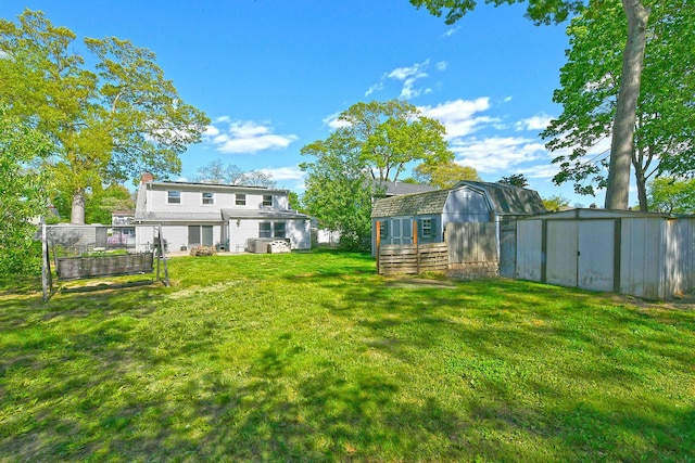63 William St, Copiague, NY 11726 - view of grassy yard with a storage unit and an outdoor structure