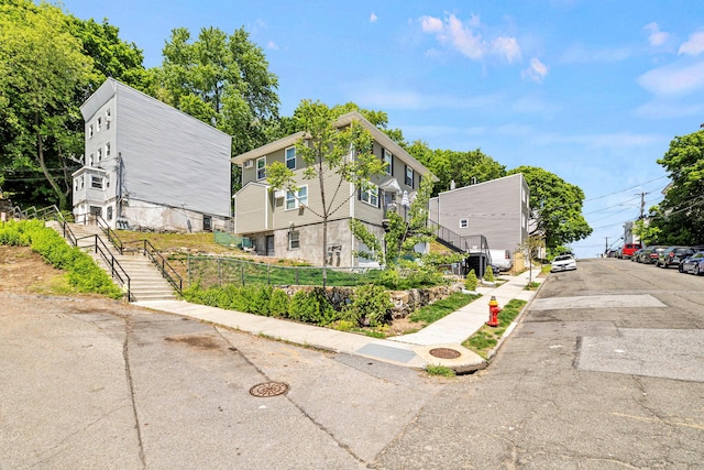 view of front of property with stairs and fence