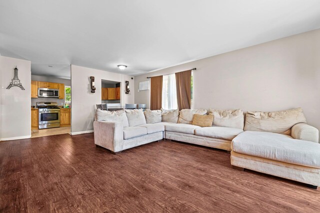 living room featuring dark wood-type flooring and baseboards