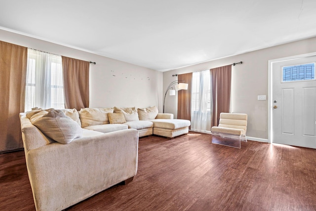living room featuring dark wood-type flooring and baseboards