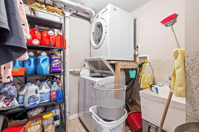 laundry room with estacked washer and dryer and tile patterned floors