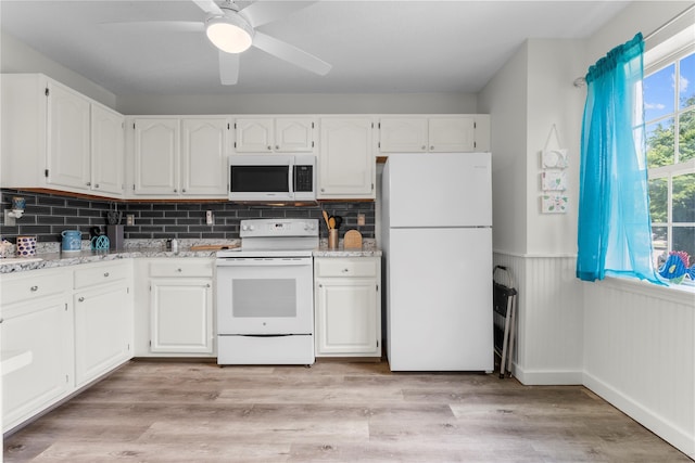 37 Spruce St, Pawling, NY 12564 - kitchen featuring white appliances, white cabinetry, wainscoting, a ceiling fan, and backsplash