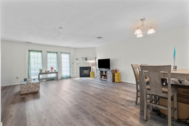 37 Spruce St, Pawling, NY 12564 - dining space with a chandelier, wood finished floors, baseboards, and a fireplace with flush hearth