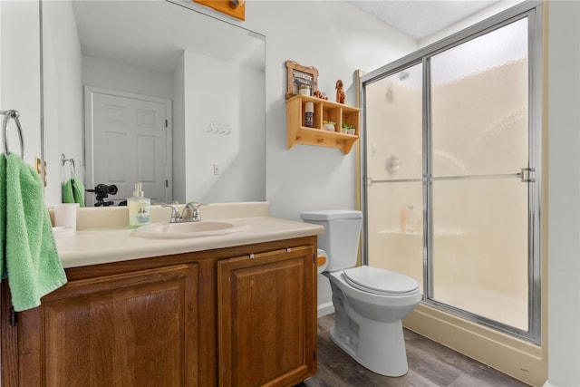 37 Spruce St, Pawling, NY 12564 - bathroom featuring wood finished floors, vanity, a stall shower, and toilet