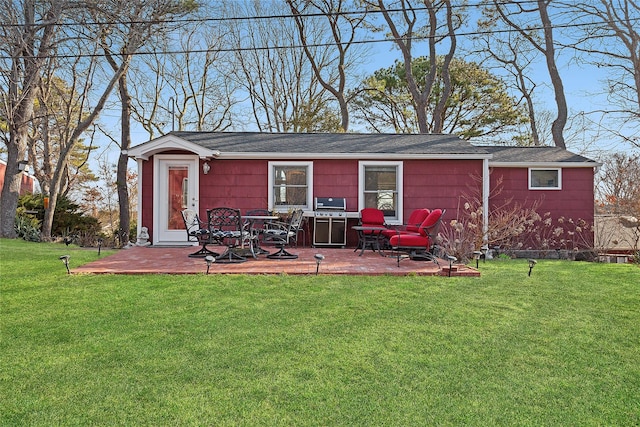 67 N Rd Unit A, Hampton Bays, NY 11946 - rear view of house with a yard and a patio area